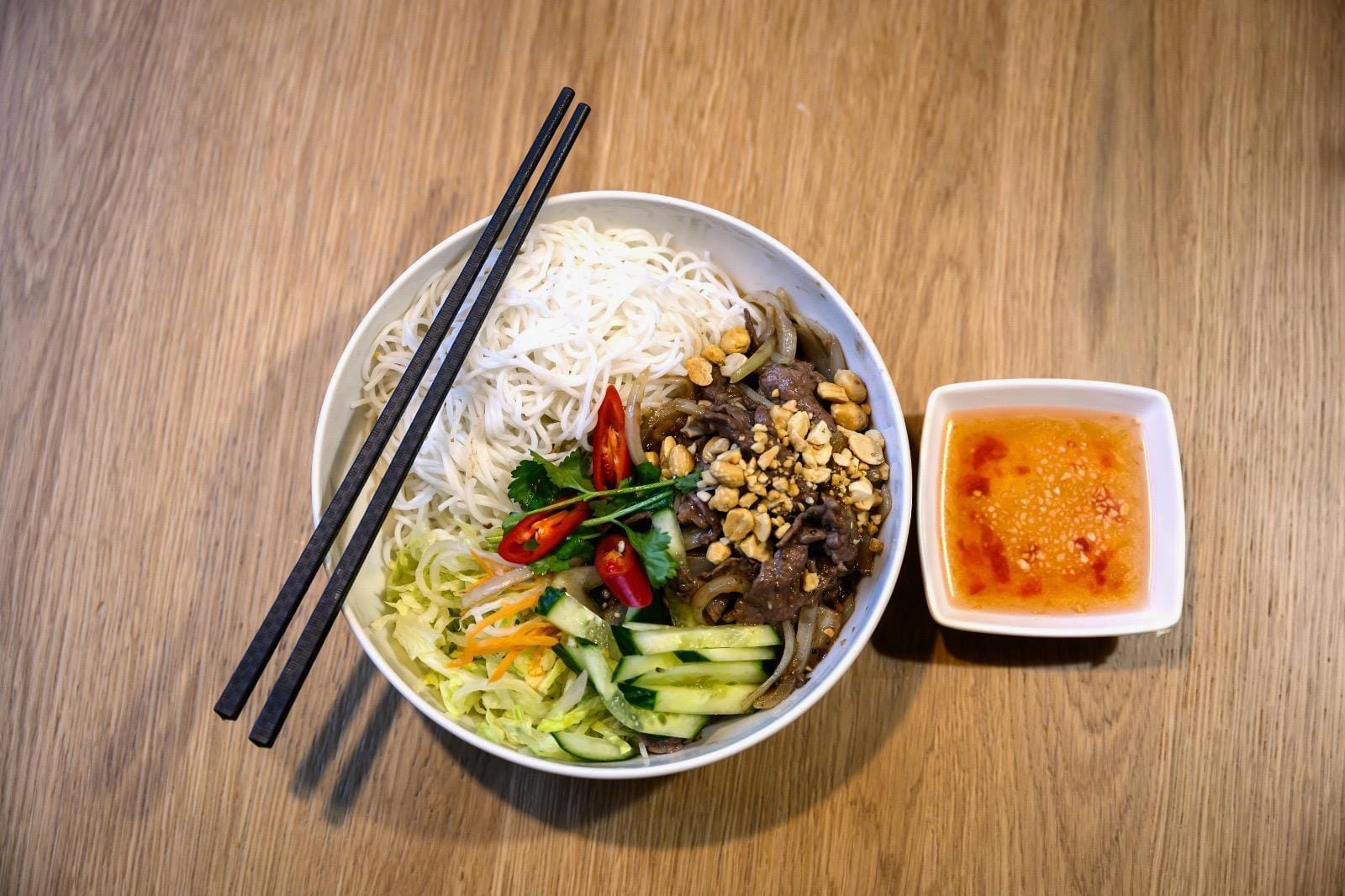 Bún bò Nam Bộ — grilled beef with cucumber, chilli, herbs, pickled carrot, peanuts and crispy shallots