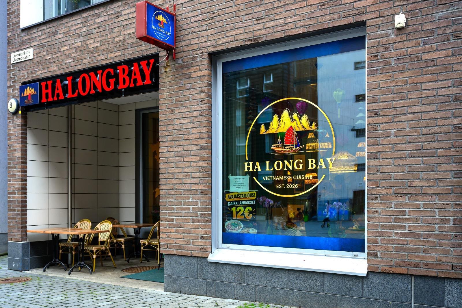 The lit Hạ Long Bếp sign above the restaurant front on Livornonkatu at dusk