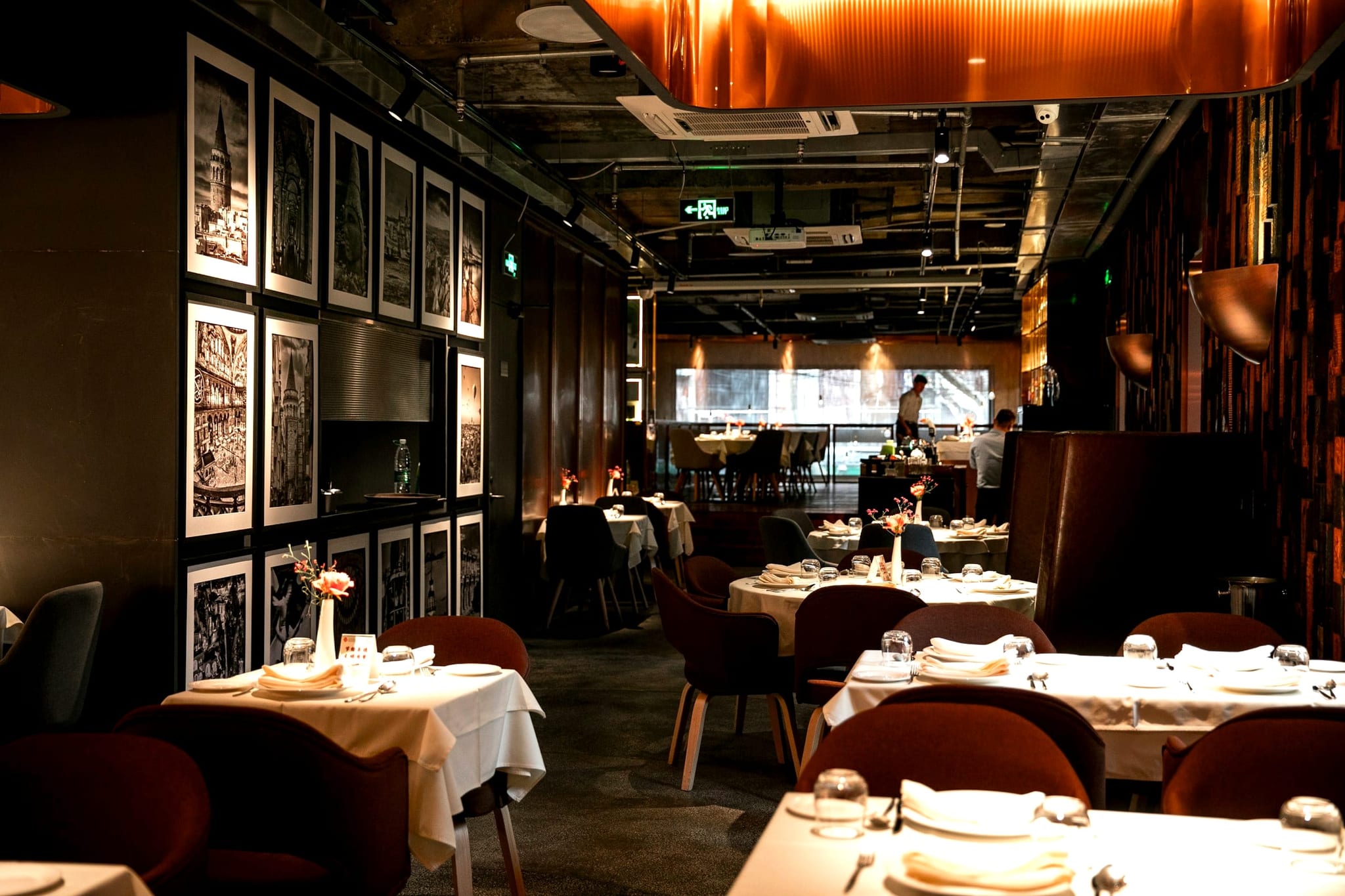 Warmly lit fine dining room set for the evening service